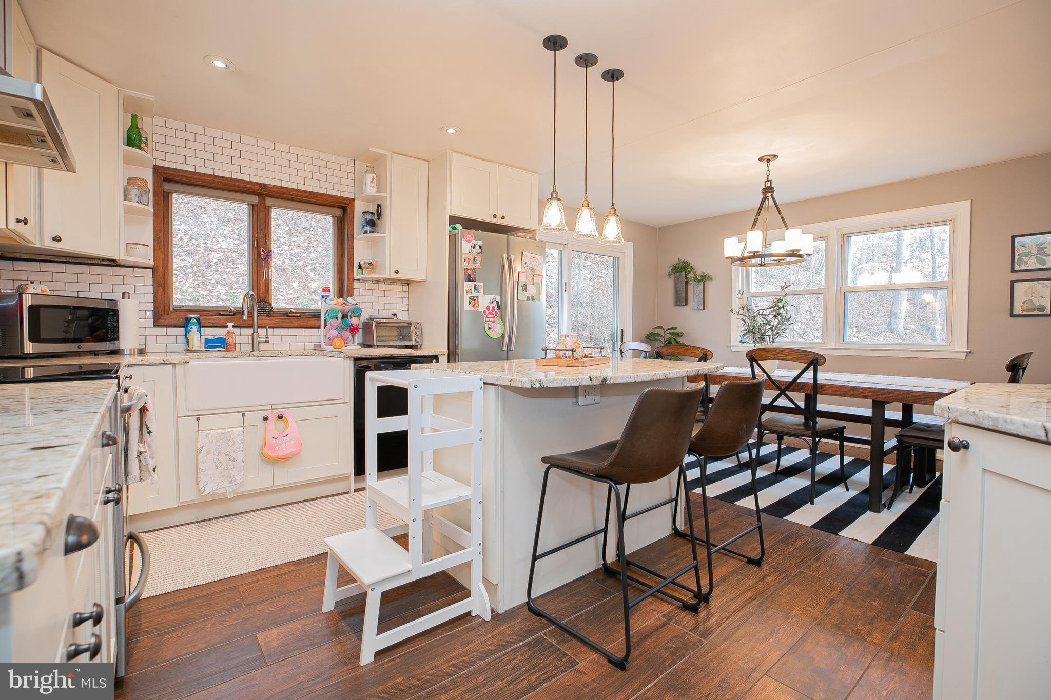 611 Brookwood Road Wayne, PA 19087 - Photo 7 of 41 a kitchen with stainless steel appliances a stove a table and chairs