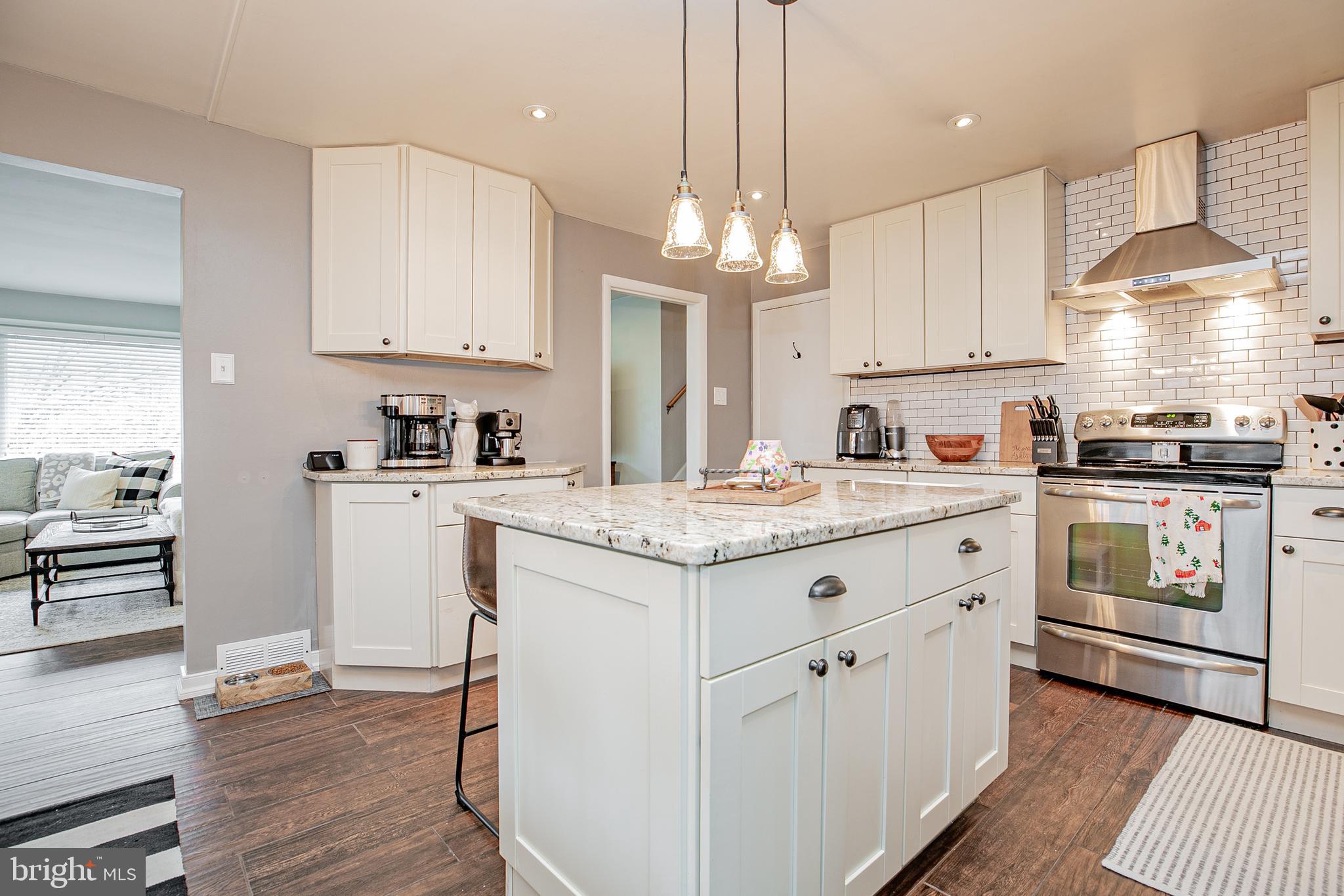 611 Brookwood Road Wayne, PA 19087 - Photo 9 of 41 a kitchen with kitchen island granite countertop a sink a counter space appliances and cabinets