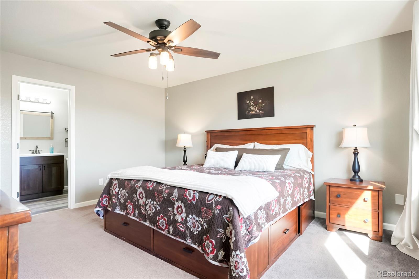 518 Draw Street Brighton, CO 80603 - Photo 13 of 35 a bedroom with a bed and a chandelier