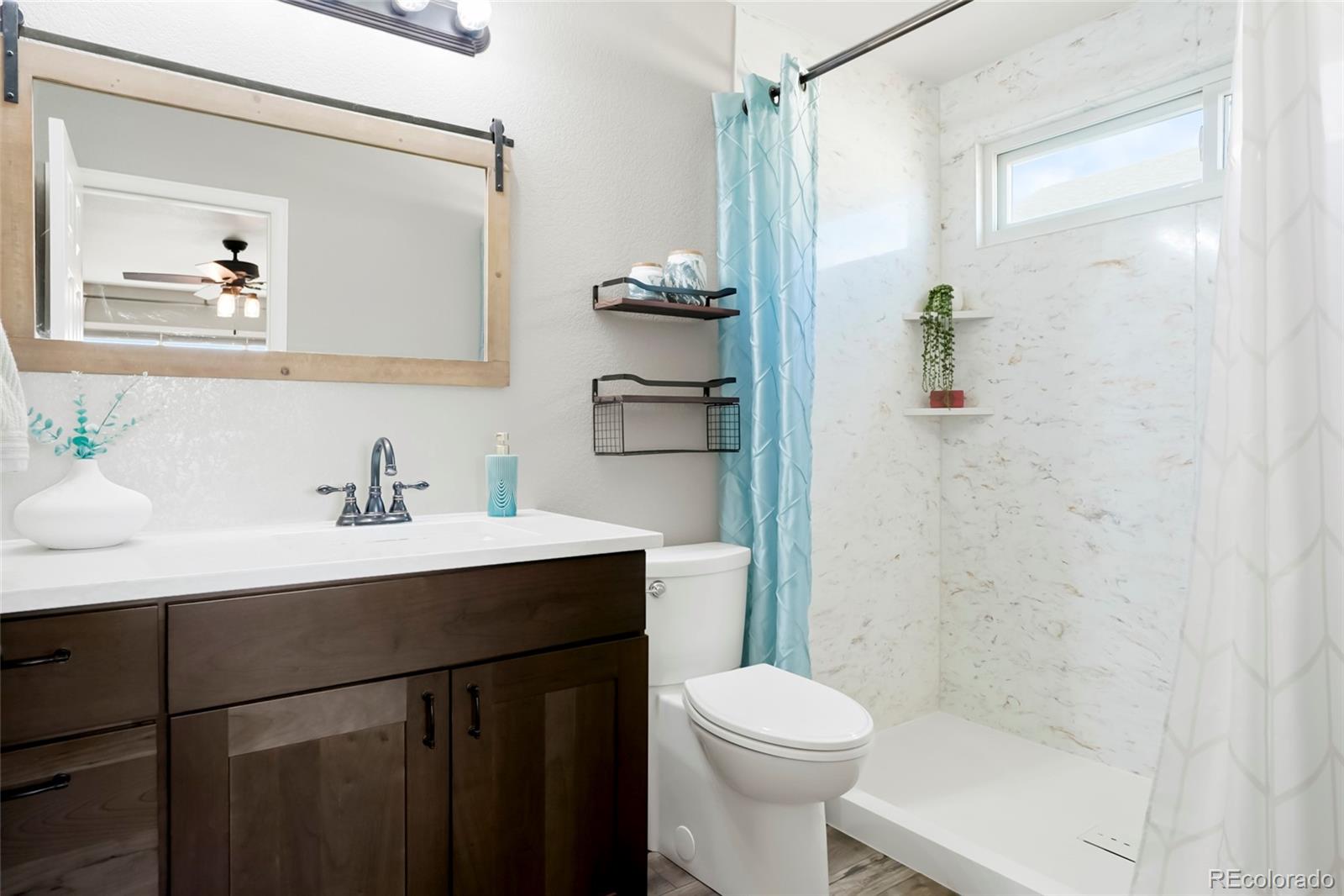518 Draw Street Brighton, CO 80603 - Photo 14 of 35 a bathroom with a sink vanity toilet and shower