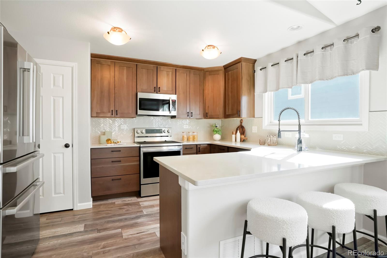 518 Draw Street Brighton, CO 80603 - Photo 2 of 35 a kitchen with a sink cabinets and wooden floor
