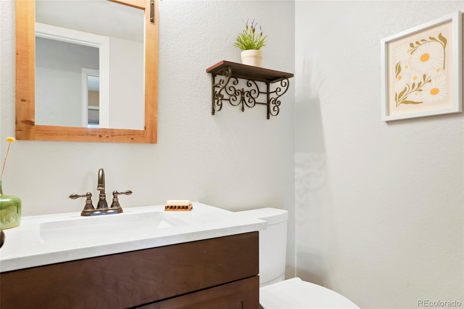 518 Draw Street Brighton, CO 80603 - Photo 24 of 35 a bathroom with a sink a toilet and mirror