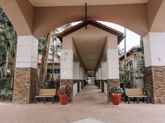 10245 Vía Hibiscus, Unit 10245 Boca Raton, FL 33428 - Photo 25 of 28 a view of entryway with outdoor seating