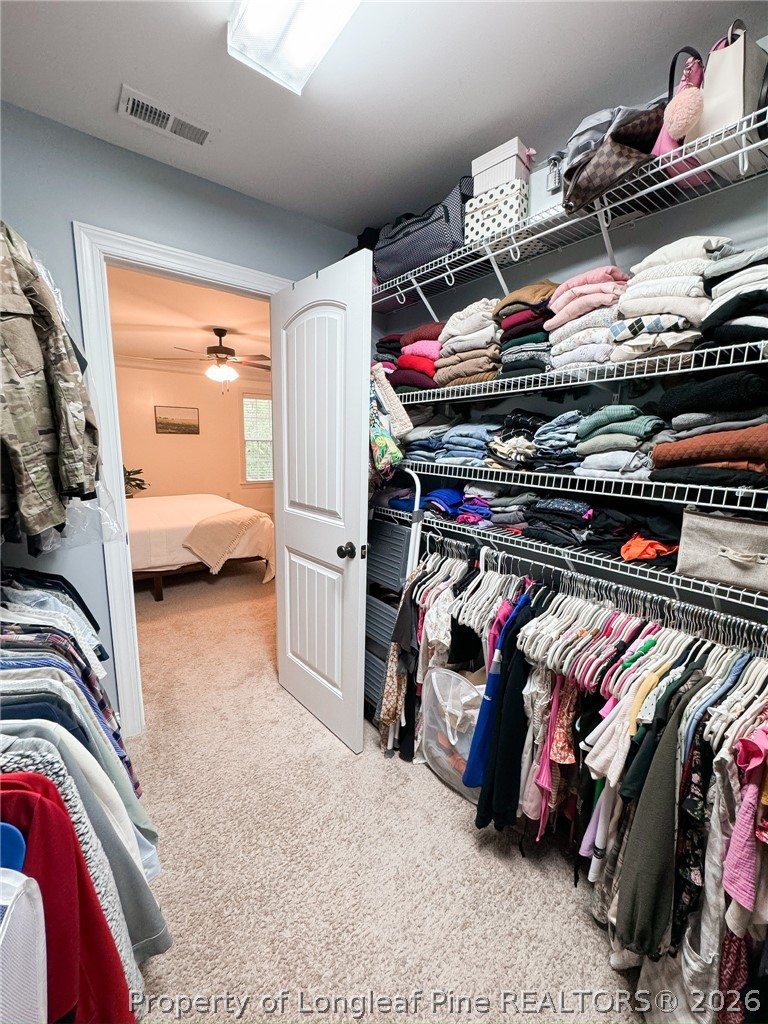 93 Falcon Ridge Drive Spring Lake, NC 28390 - Photo 34 of 50 a view of walk in closet with clothes and shoes