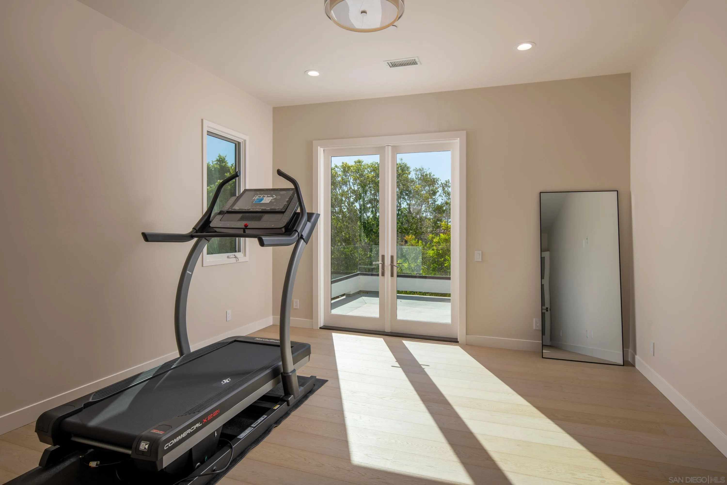 9521 La Jolla Farms Road La Jolla, CA 92037 - Photo 46 of 55 a room with gym equipment and a large window