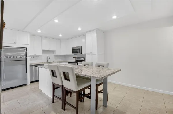 a kitchen with a table and chairs in it