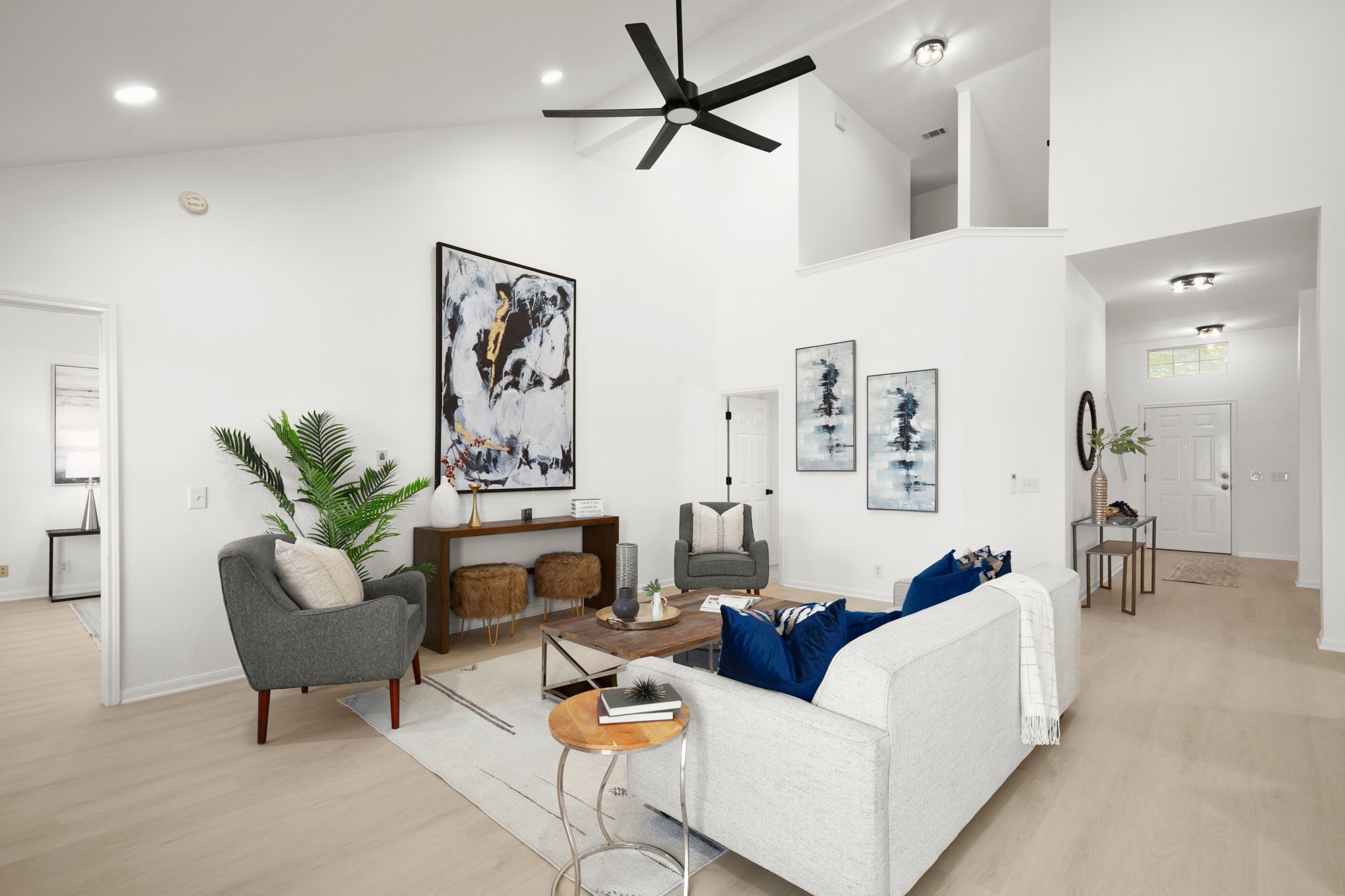 310 Bailey Loop Kyle, TX 78640 - Photo 11 of 30 Living room with light wood-style flooring, a ceiling fan, and vaulted ceiling