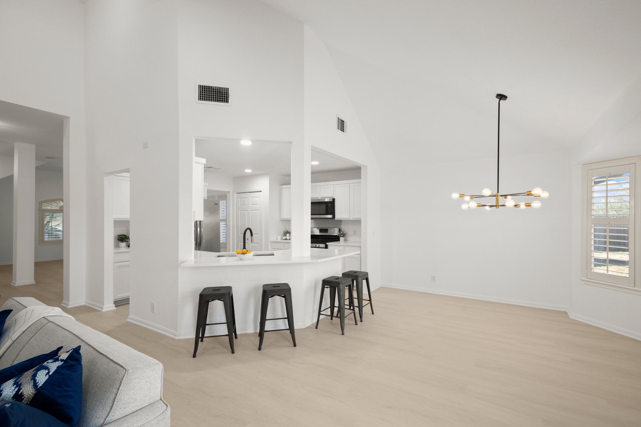 310 Bailey Loop Kyle, TX 78640 - Photo 30 of 30 Kitchen with white cabinetry, open floor plan, a breakfast bar area, suspended lighting, and stainless steel appliances