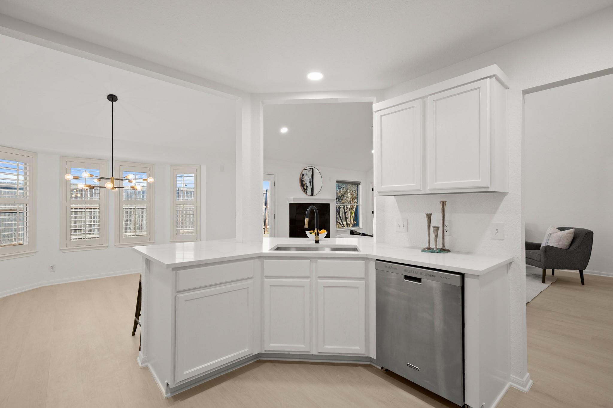 310 Bailey Loop Kyle, TX 78640 - Photo 14 of 30 Kitchen featuring dishwasher, white cabinetry, a peninsula, light wood-type flooring, and suspended lighting