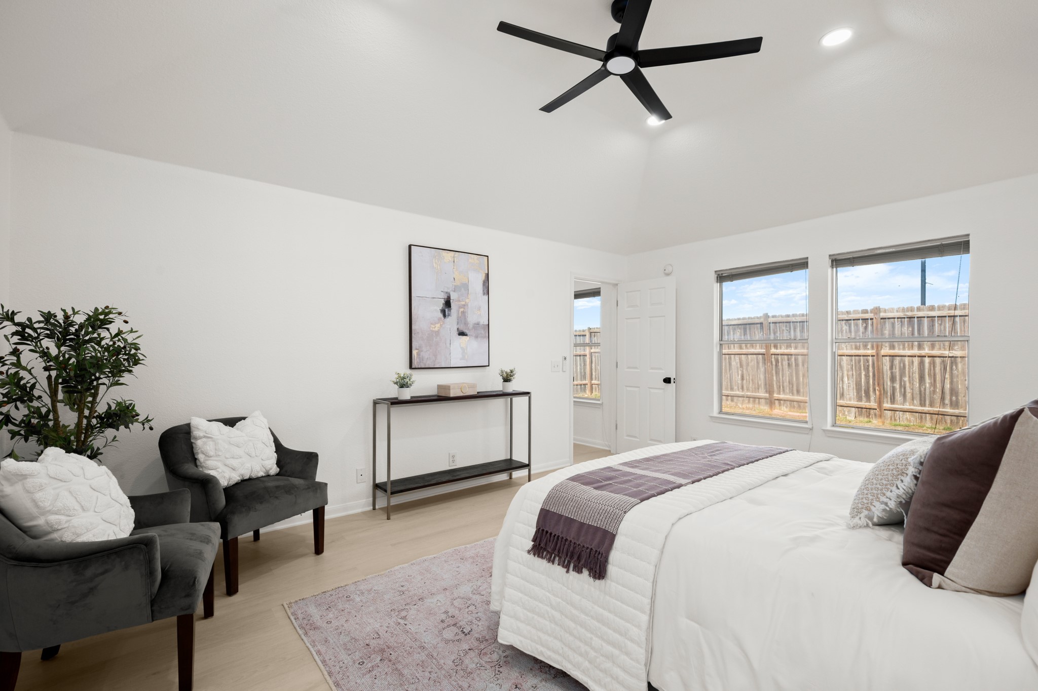 310 Bailey Loop Kyle, TX 78640 - Photo 18 of 30 Bedroom with light wood finished floors, lofted ceiling, a ceiling fan, and recessed lighting