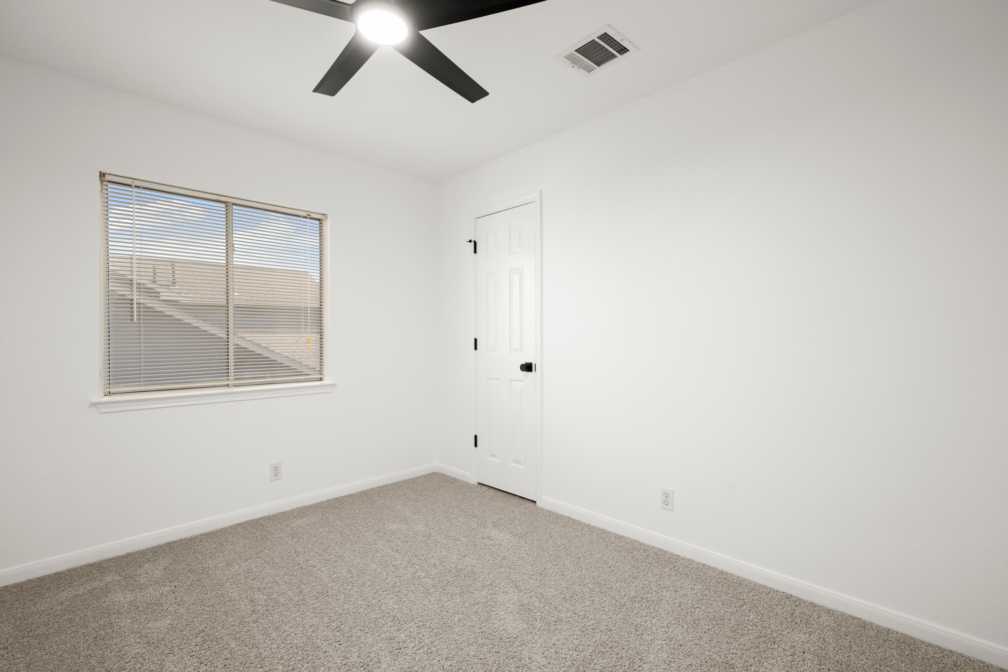 310 Bailey Loop Kyle, TX 78640 - Photo 23 of 30 Empty room with light colored carpet and ceiling fan