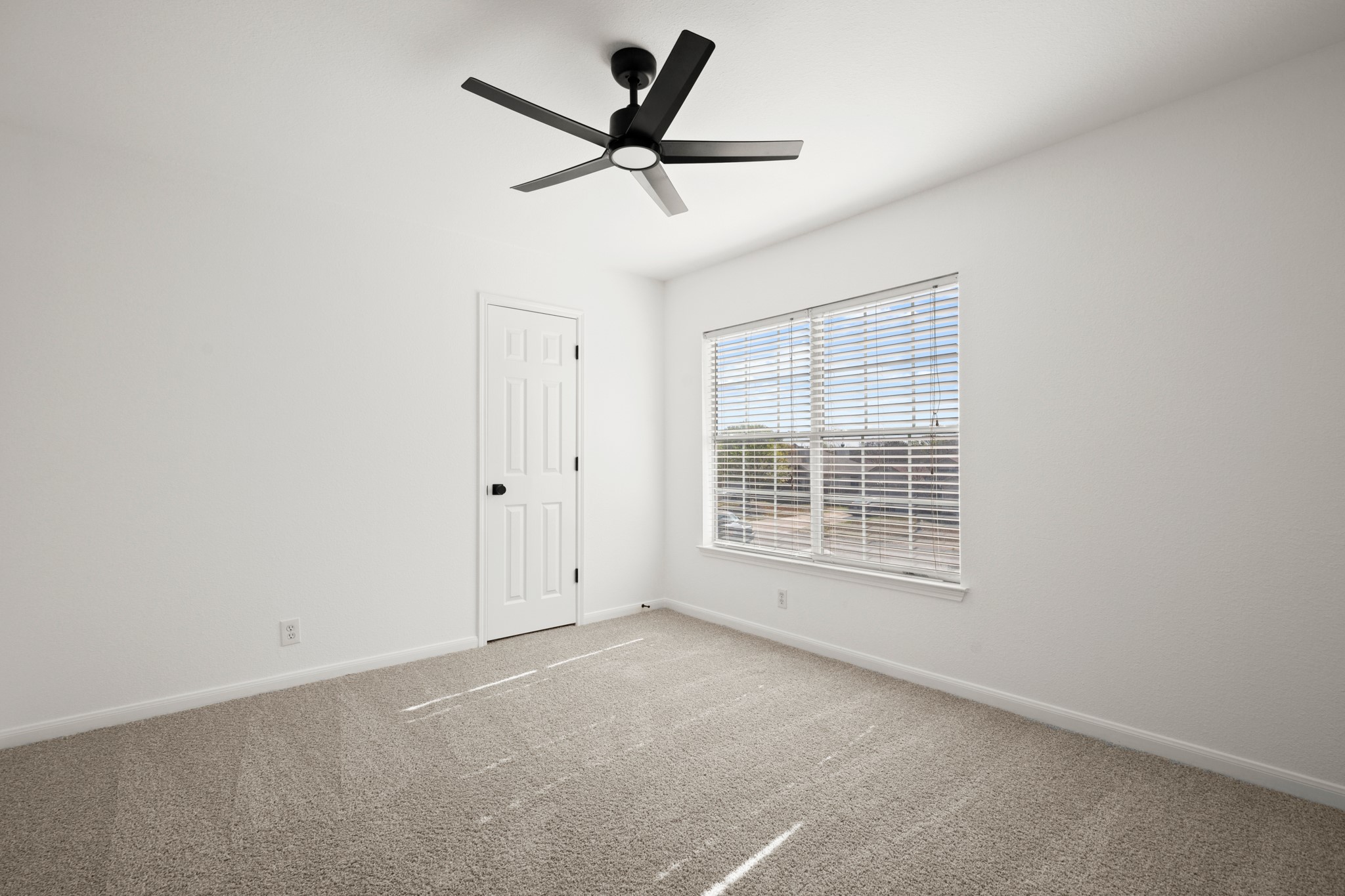 310 Bailey Loop Kyle, TX 78640 - Photo 24 of 30 Empty room with light carpet and a ceiling fan