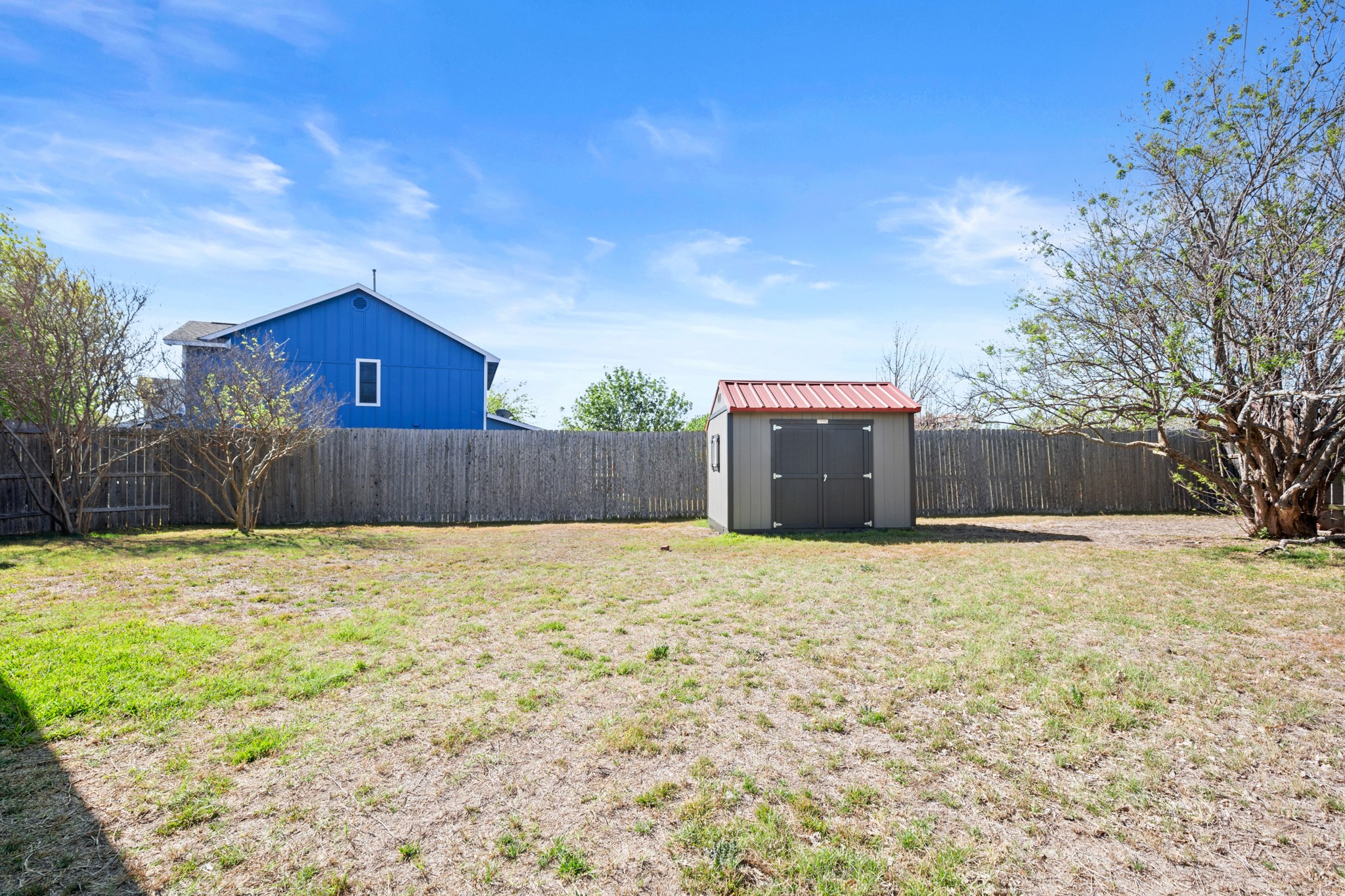310 Bailey Loop Kyle, TX 78640 - Photo 26 of 30 Fenced backyard featuring a storage shed