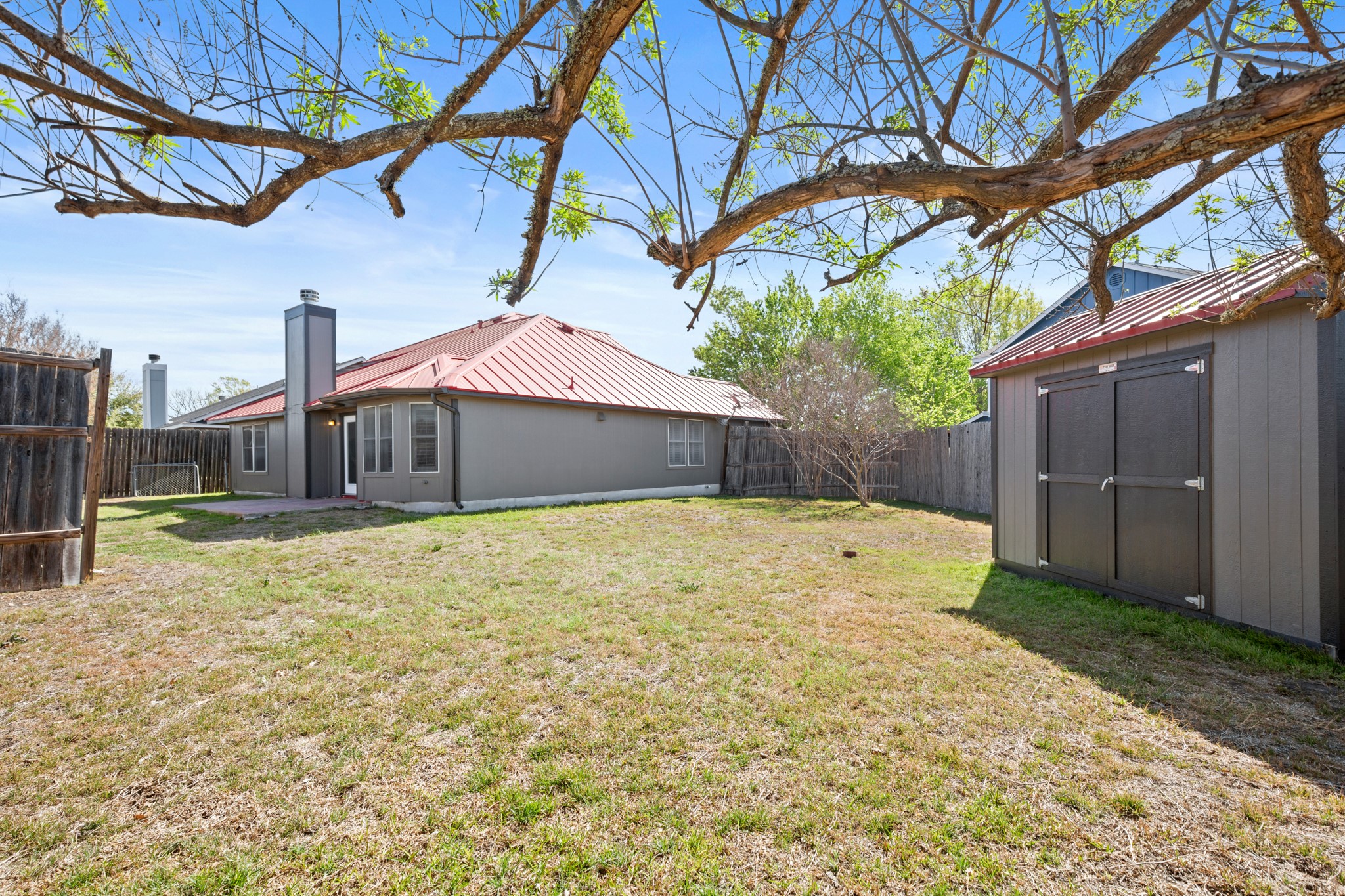 310 Bailey Loop Kyle, TX 78640 - Photo 29 of 30 Fenced backyard with a shed and a patio area