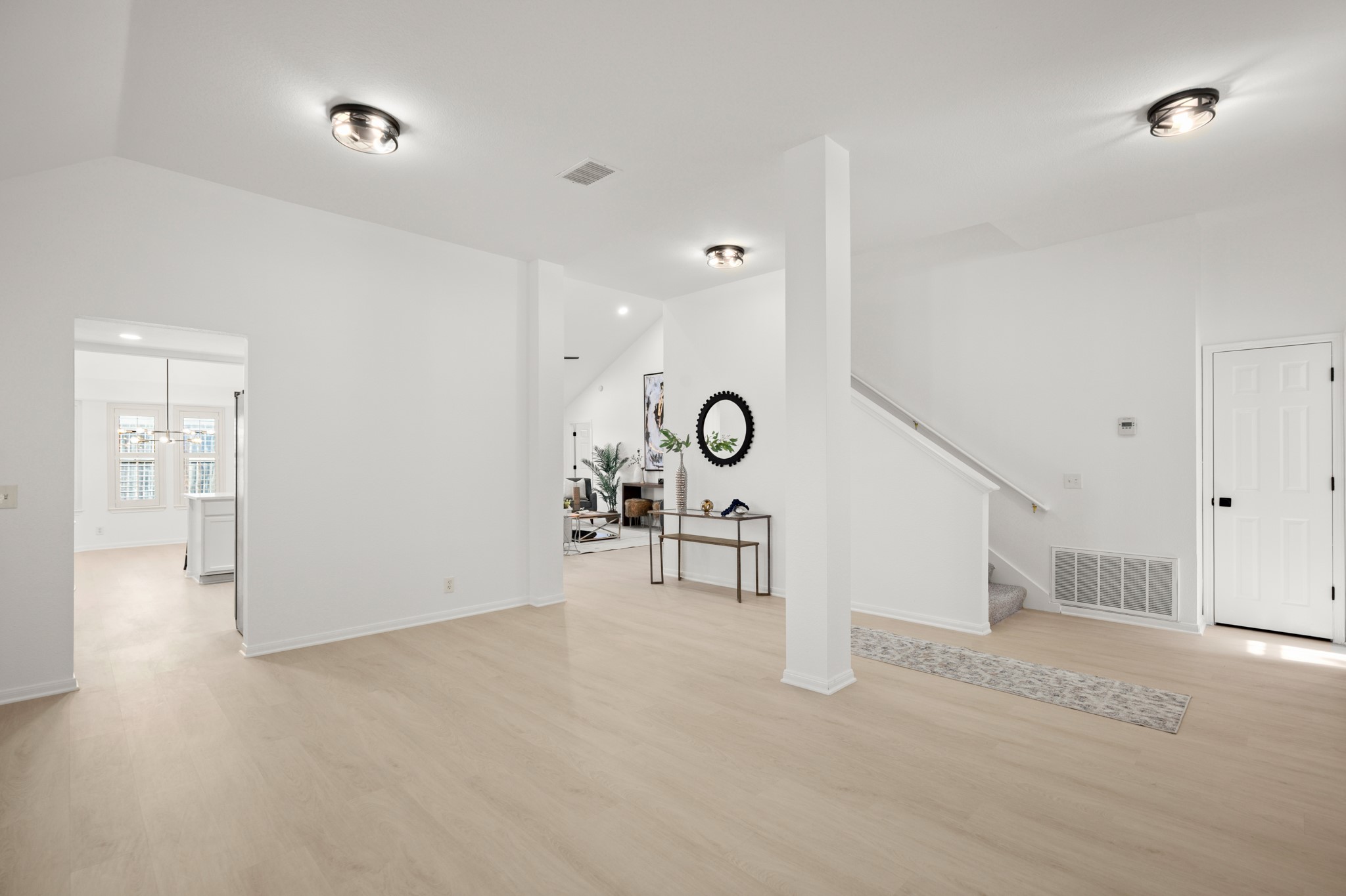 310 Bailey Loop Kyle, TX 78640 - Photo 5 of 30 Unfurnished living room featuring light wood-type flooring and vaulted ceiling
