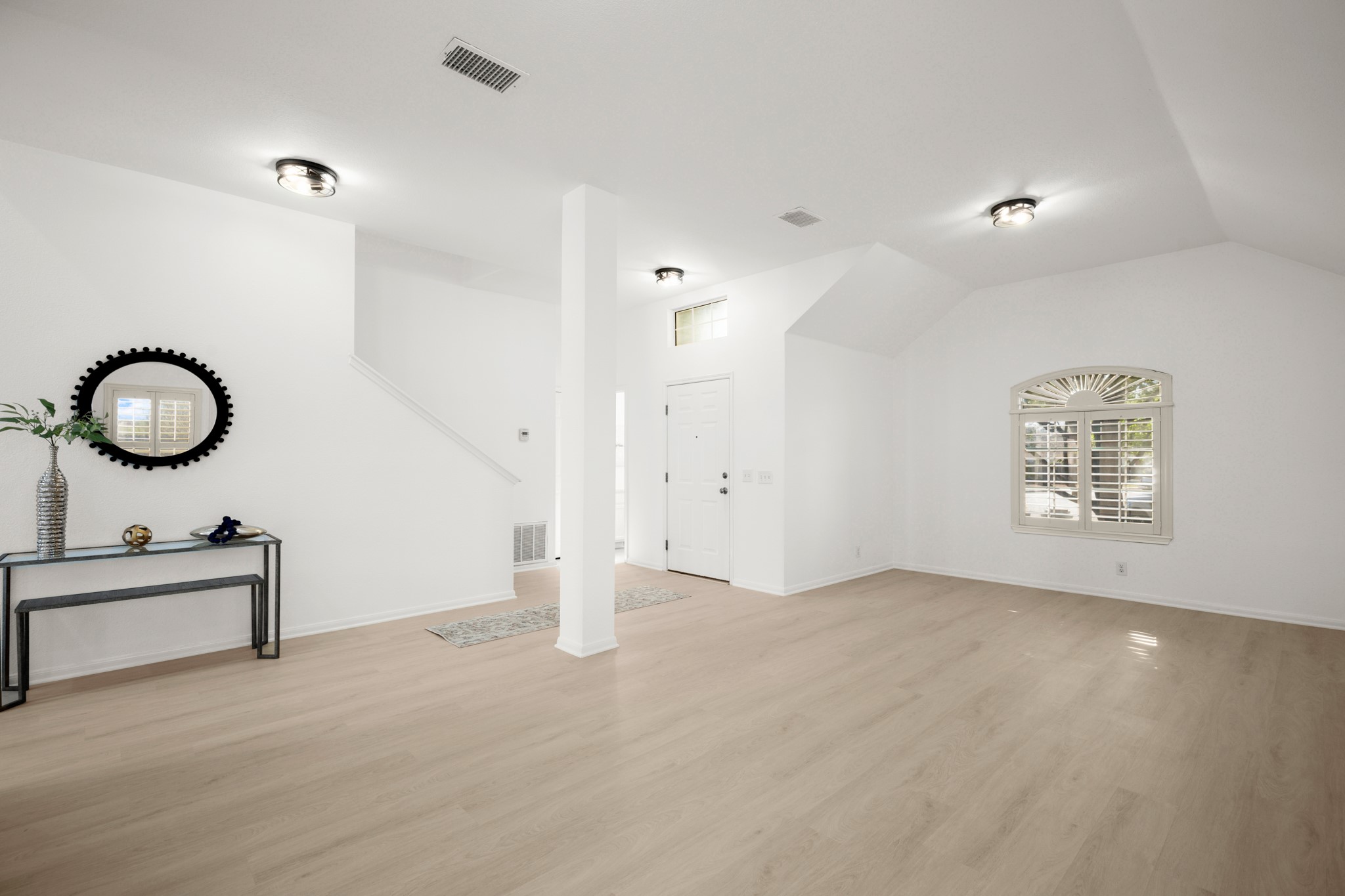 310 Bailey Loop Kyle, TX 78640 - Photo 6 of 30 Unfurnished living room featuring light wood-style floors and vaulted ceiling