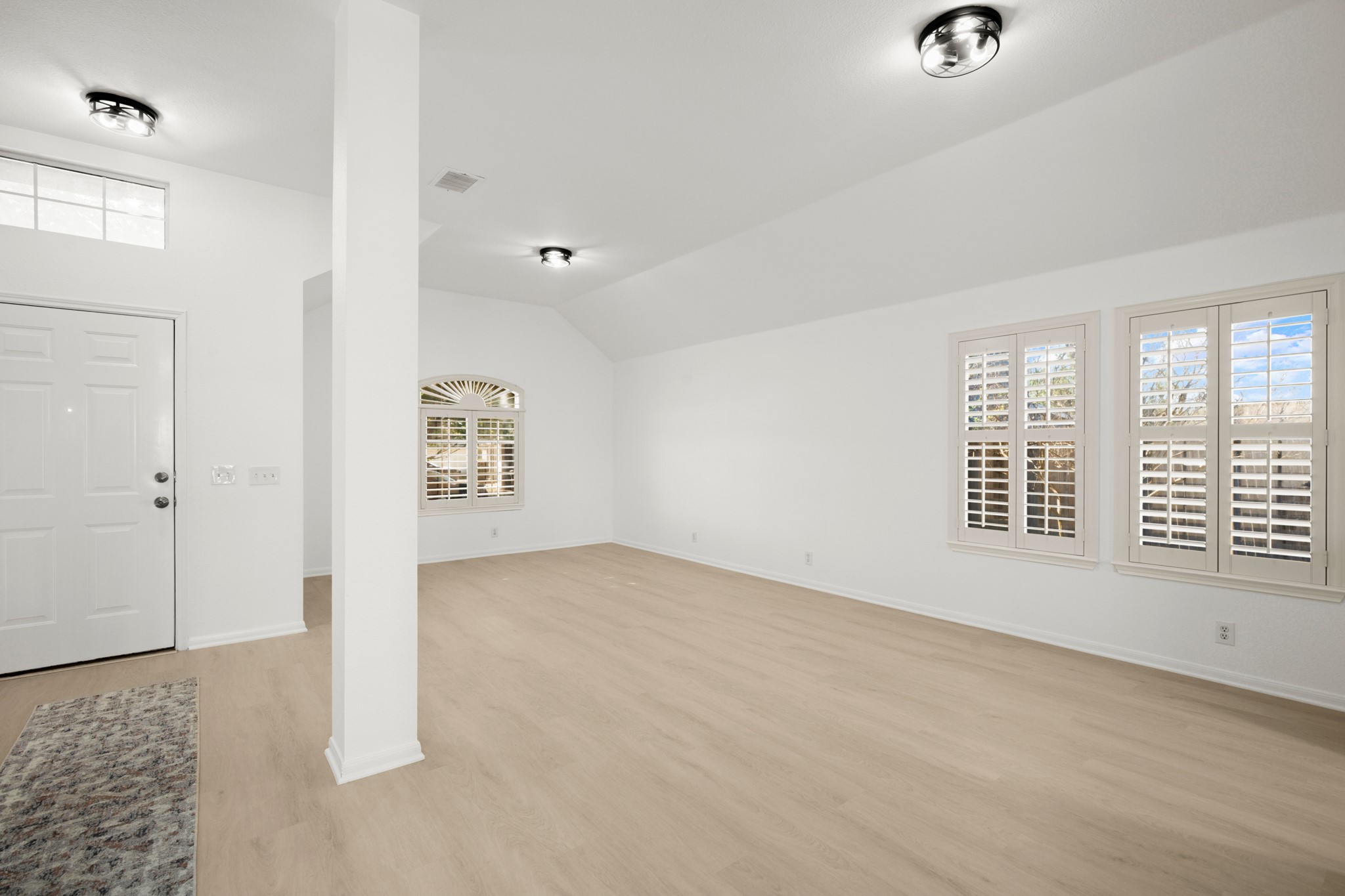 310 Bailey Loop Kyle, TX 78640 - Photo 7 of 30 Foyer entrance with light wood-style floors and vaulted ceiling