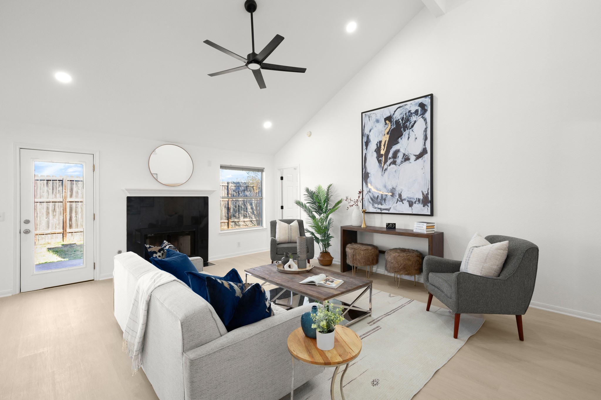 310 Bailey Loop Kyle, TX 78640 - Photo 9 of 30 Living room featuring a ceiling fan, recessed lighting, lofted ceiling, a fireplace, and light wood-style flooring