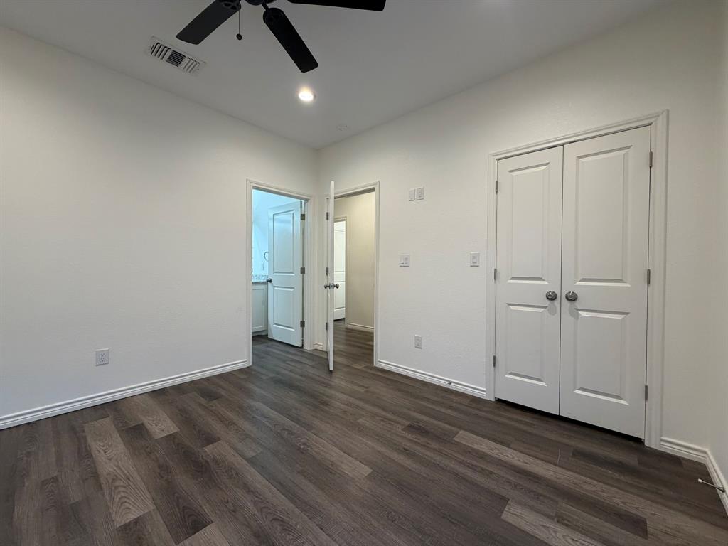 613 West Parnell Street Denison, TX 75020 - Photo 11 of 14 an empty room with wooden floor and windows