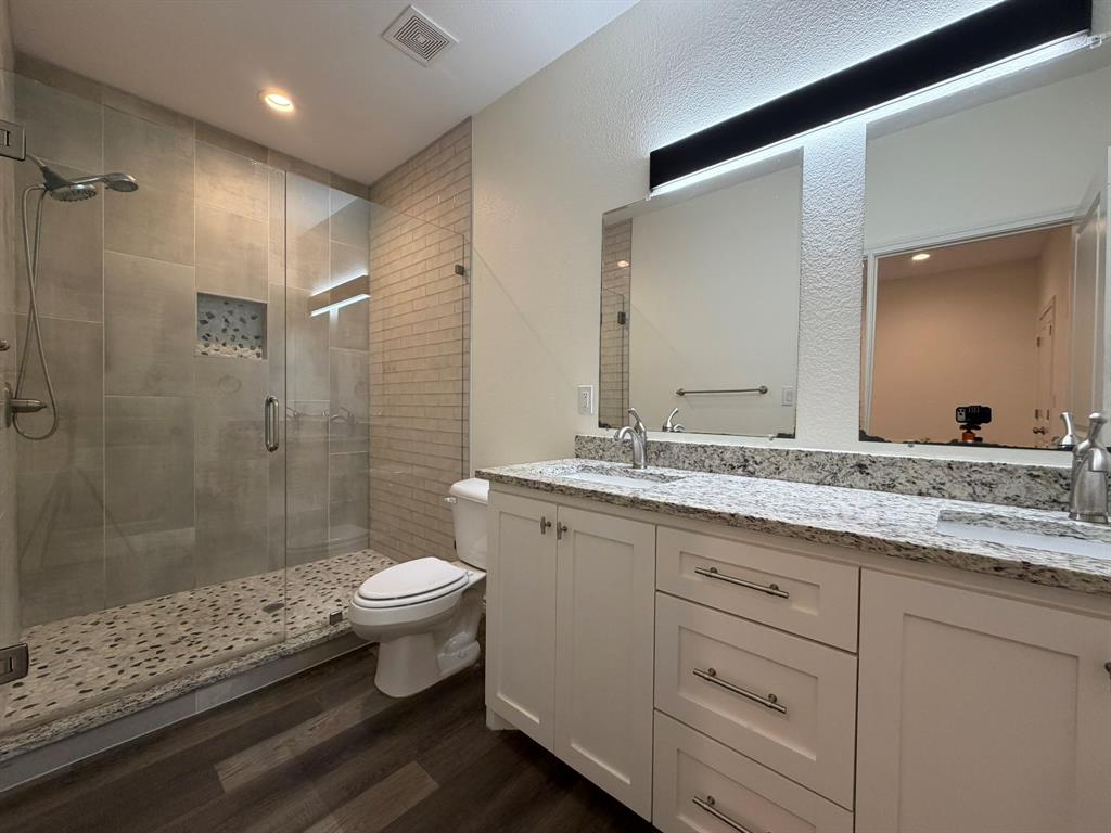 613 West Parnell Street Denison, TX 75020 - Photo 12 of 14 a bathroom with a granite countertop sink toilet and shower