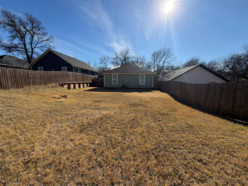613 West Parnell Street Denison, TX 75020 - Photo 14 of 14 a large house with a large tree in front of it