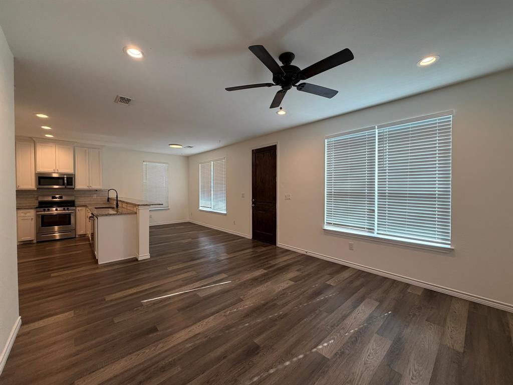 613 West Parnell Street Denison, TX 75020 - Photo 5 of 14 a view of an empty room with a window and wooden floor