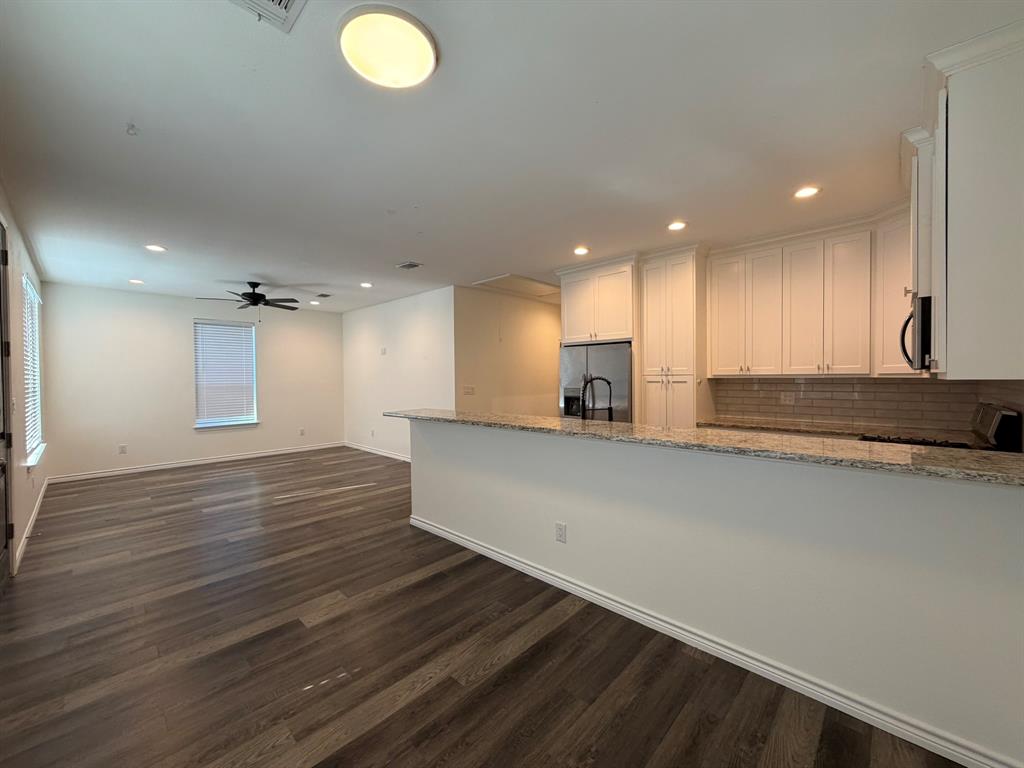 613 West Parnell Street Denison, TX 75020 - Photo 6 of 14 an empty room with wooden floor and windows