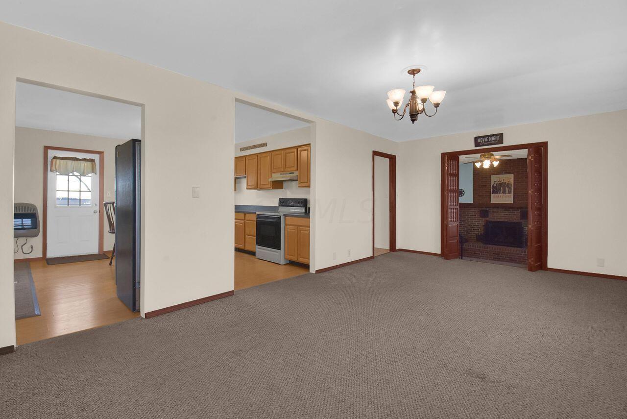 Living room entry with views of kitchen and access to family room/bedroom.