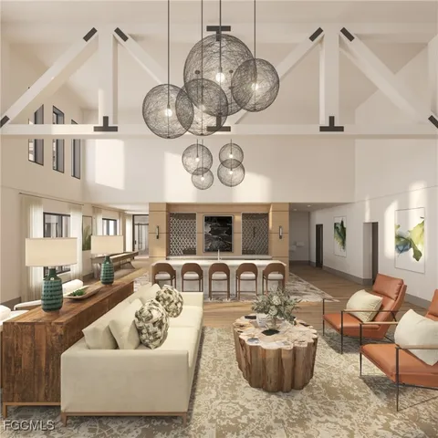 a living room with furniture kitchen view and a chandelier