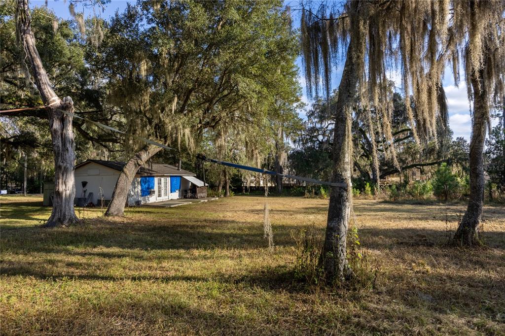 560 Northwest 39th Road Gainesville, FL 32607 - Photo 5 of 13 a view of a house with a yard and tree s
