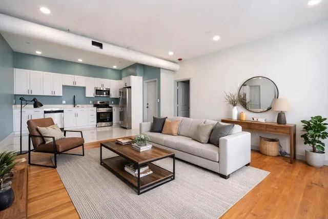 a living room with furniture and a wooden floor