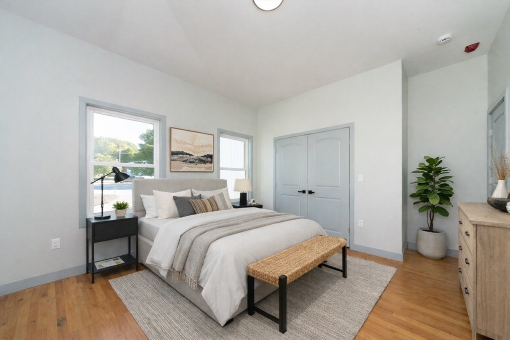 115-117 Mechanic Street, Unit 3 Clinton, MA 01510 - Photo 6 of 17 a bedroom with a bed and a potted plant