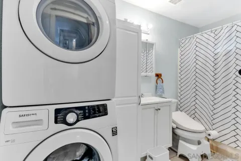 a white toilet sitting next to a bathroom sink