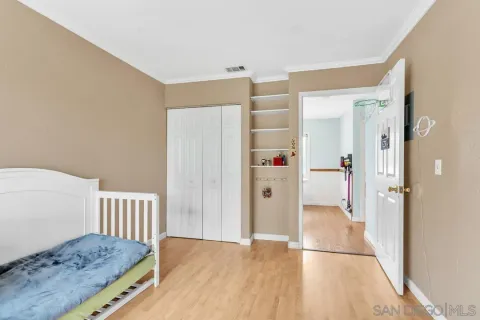 a bathroom with a granite countertop toilet sink and mirror