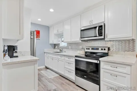 a kitchen with stainless steel appliances a refrigerator and cabinets