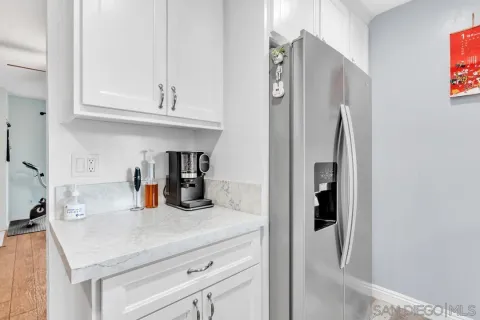 a kitchen with stainless steel appliances granite countertop a sink and a refrigerator