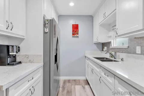 a view of a dining room with furniture and a potted plant