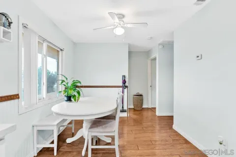 a view of a dining room with furniture and a potted plant