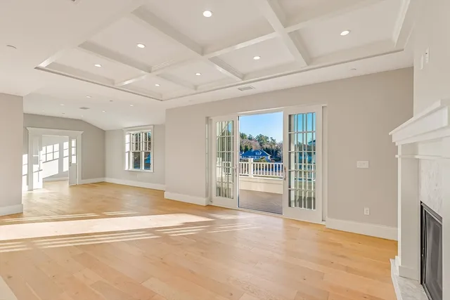 a view of livingroom with an entryway and wooden floor