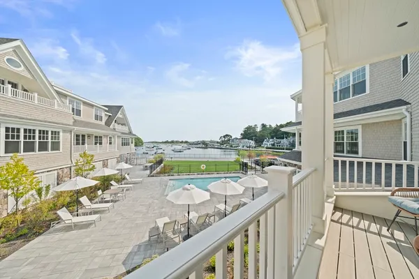 a view of a balcony with wooden floor and outdoor seating