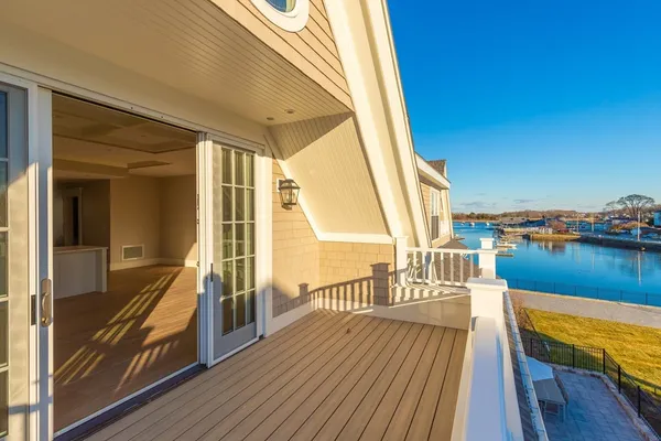 a view of a balcony with chairs and wooden floor