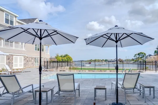 a view of a chairs and table in the patio with a fire pit