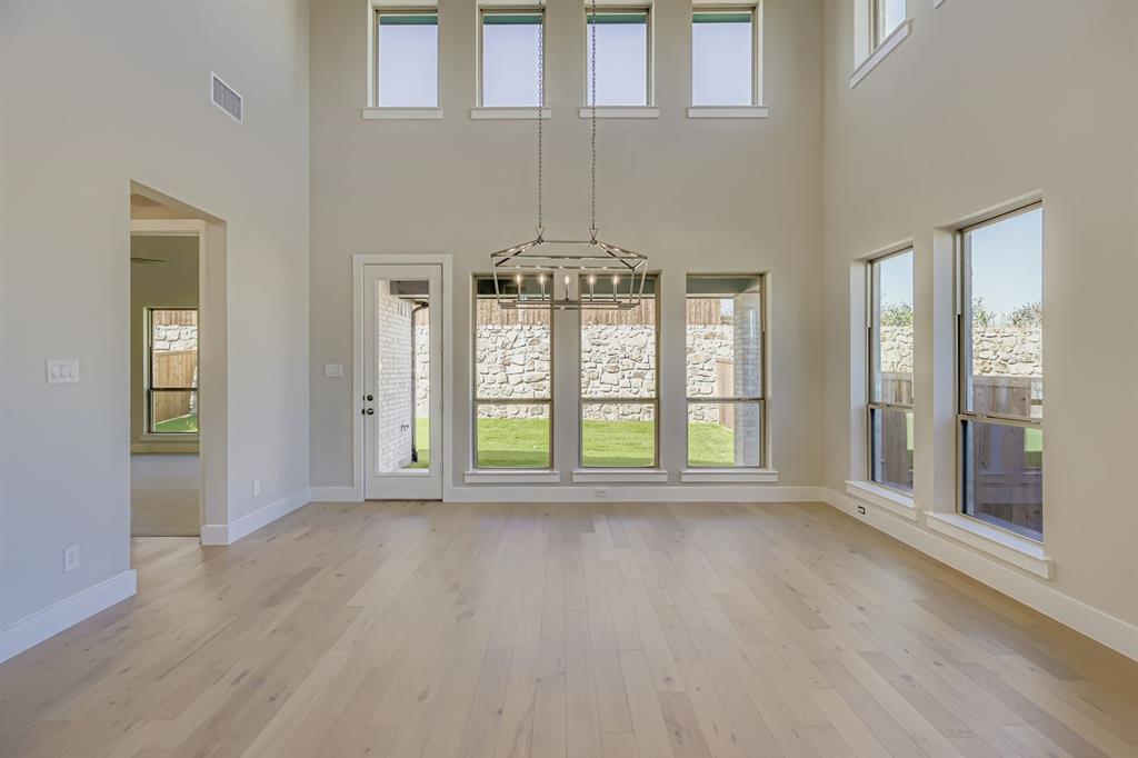 4203 Windy Point Court Oak Point, TX 75068 - Photo 7 of 29 a view of an empty room with wooden floor and a window