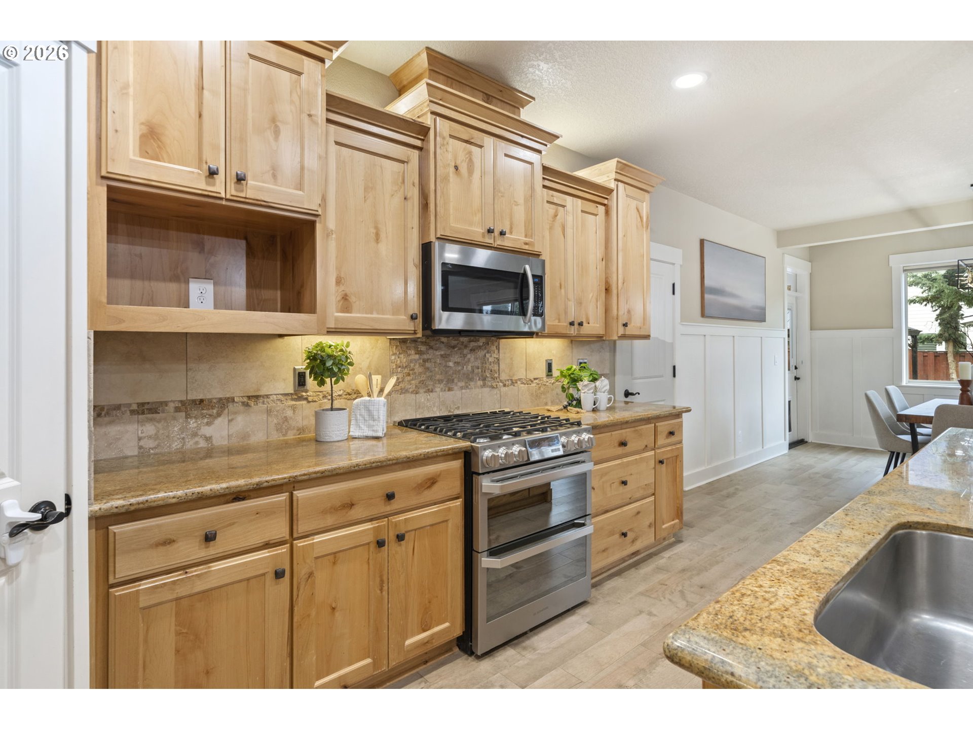 22421 Southwest Sequoia Terrace Sherwood, OR 97140 - Photo 16 of 48 a kitchen with stainless steel appliances granite countertop a stove a sink and a microwave
