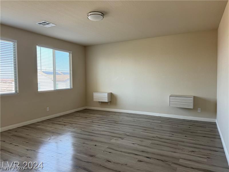 9056 Tony Ridge Avenue Las Vegas, NV 89148 - Photo 15 of 32 Well-lit living space with durable, low-maintenance flooring offers practical everyday comfort.