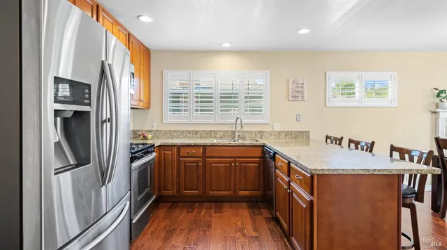 a kitchen with stainless steel appliances granite countertop a stove and a sink