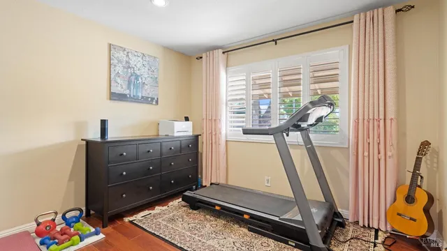 a bathroom with a granite countertop sink mirror vanity and toilet