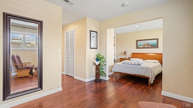 a bedroom with furniture and a wooden floor
