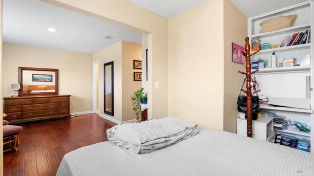 a bedroom with a bed and a book shelf