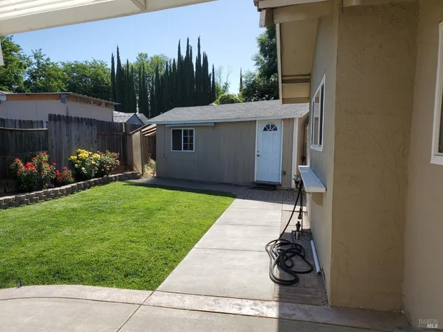 a view of a house with sitting area and garden